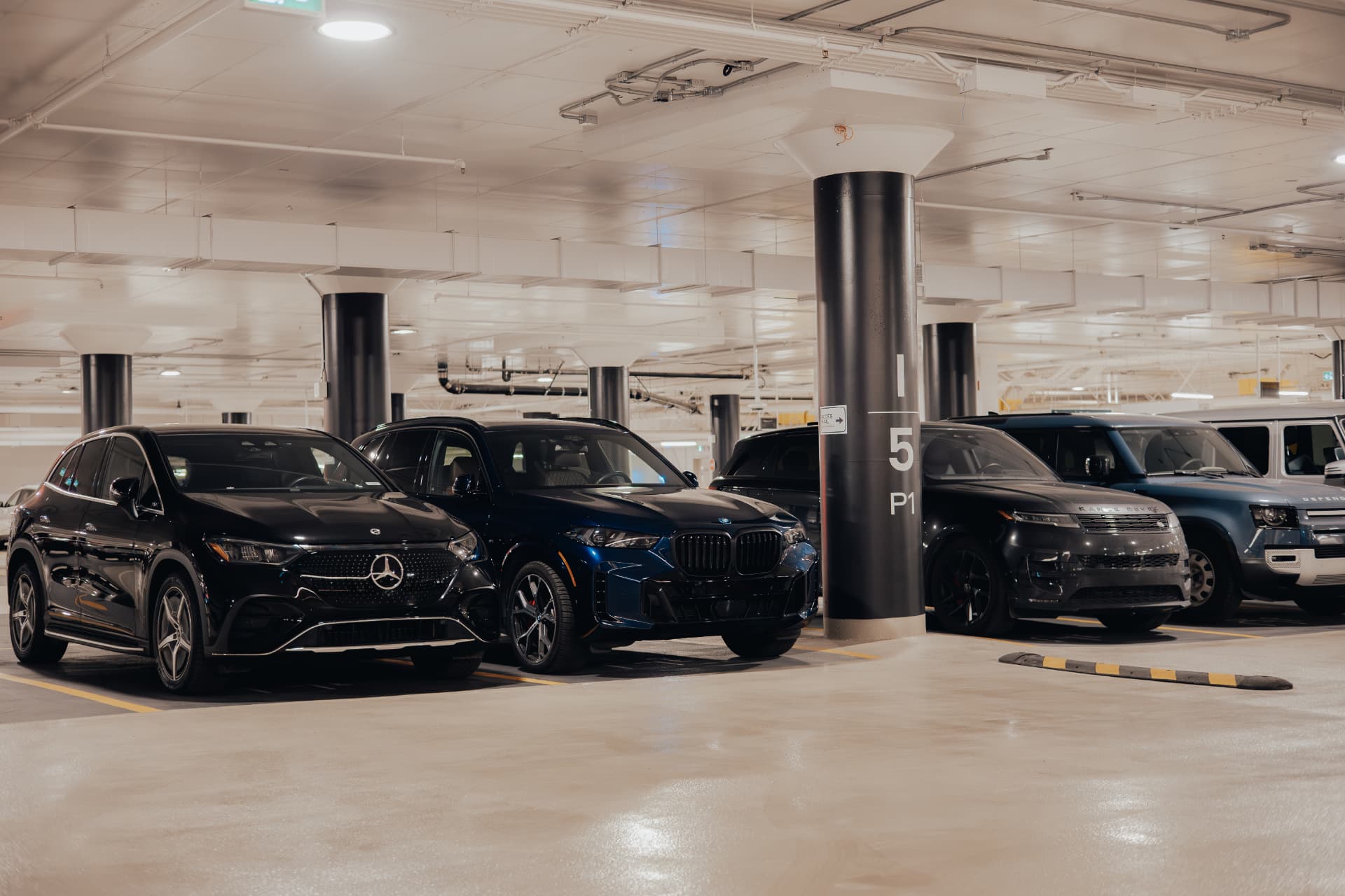 Luxury vehicles parked in an Eminent Valet managed underground parking facility